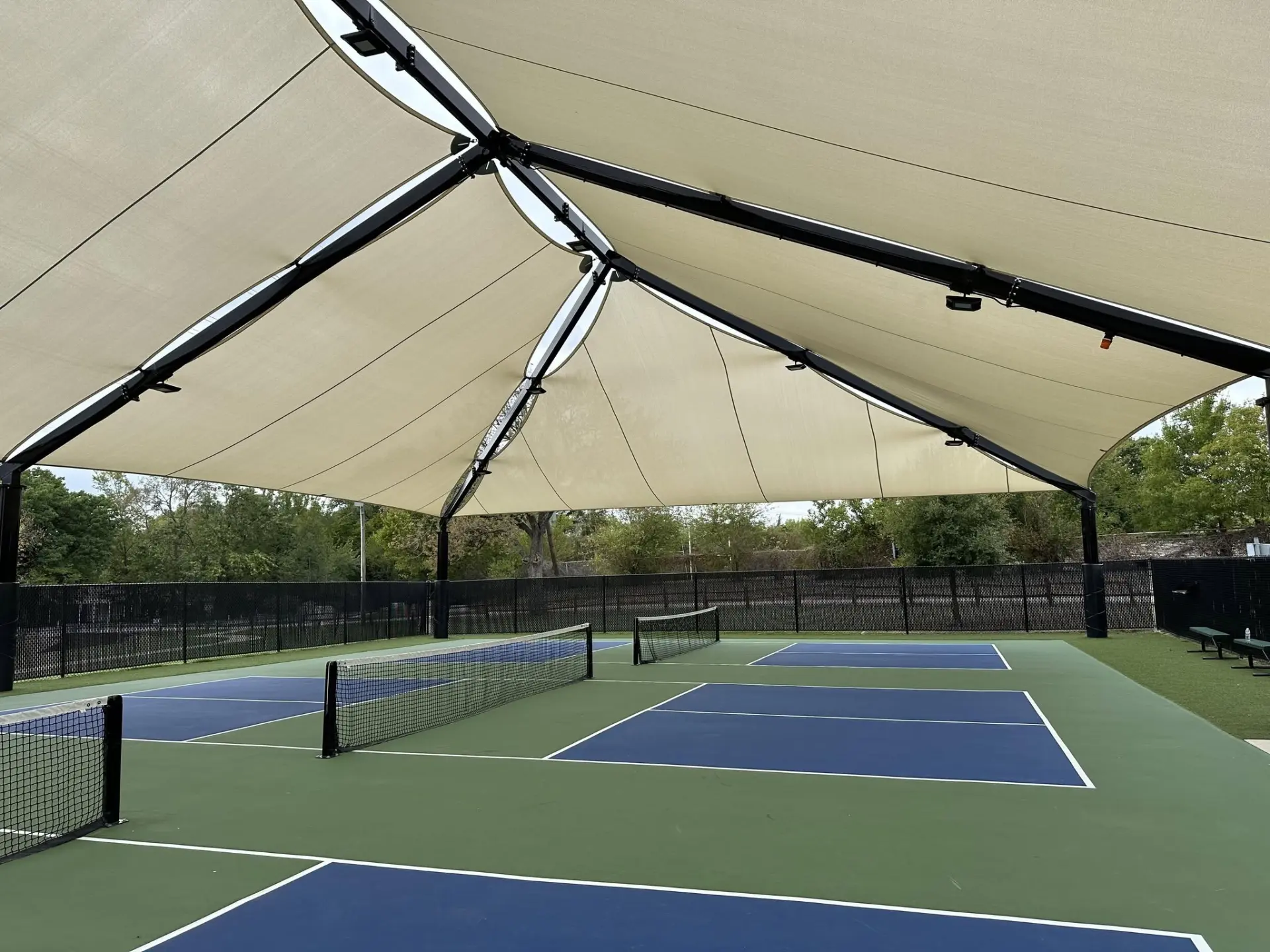 Covered double pickleball court built in Houston with blue and green surface
